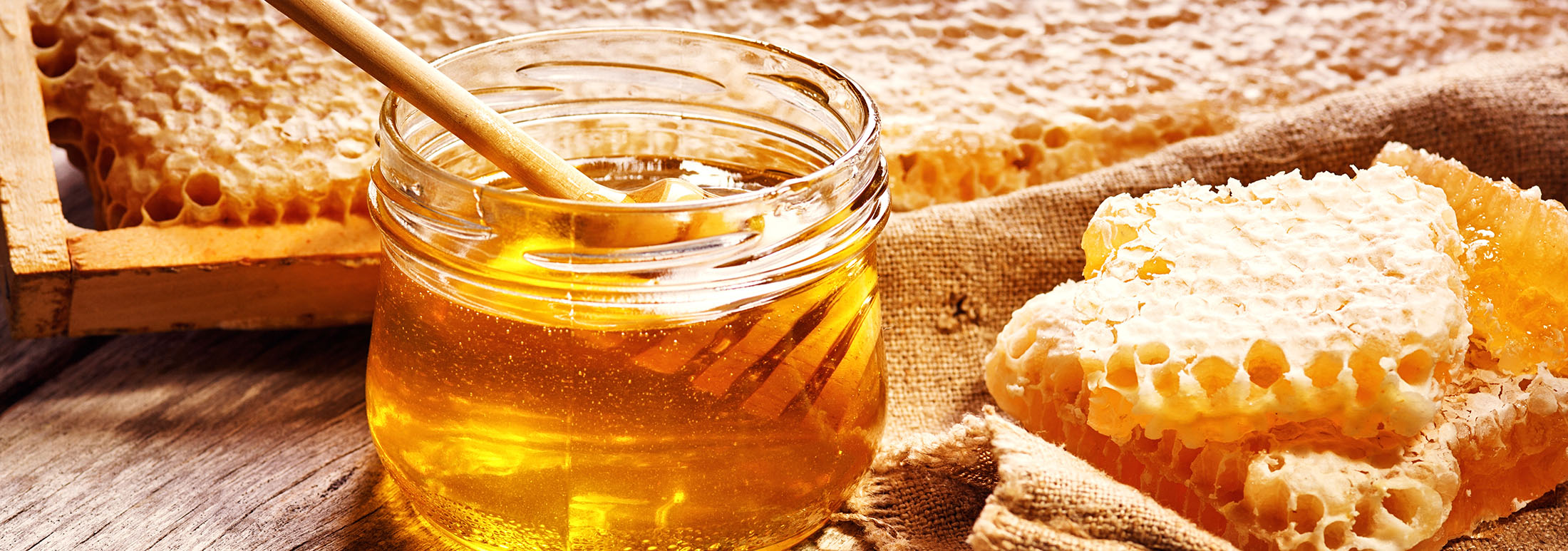 Sweet honey in the comb, glass jar.